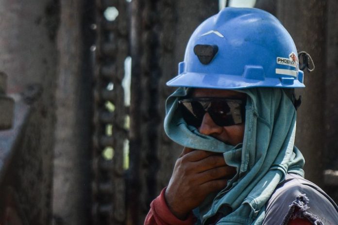 A miner looks on at rescue efforts in Pinabete